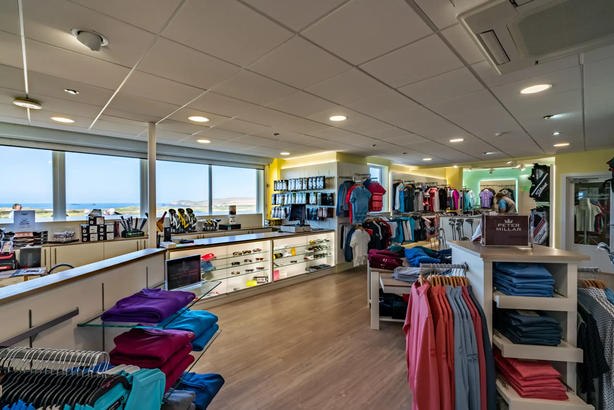 Golf shop Cornwall offering golf course equipment hire with clothing, accessories, and gear on display.